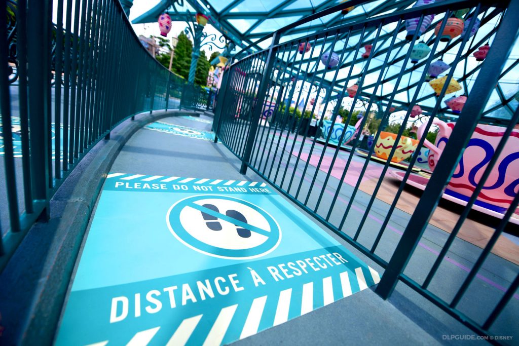 Physical distancing floor sticker in queue line of Disneyland Paris attraction